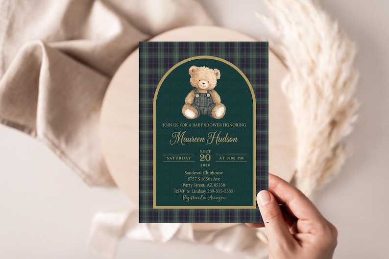 May include: A baby shower invitation featuring a teddy bear illustration. The invitation has a green and navy plaid background with gold accents. The text reads "Join us for a baby shower honoring Maureen Hudson" and includes date, time, and location details.