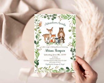 May include: A baby shower invitation with a woodland theme. The invitation features a watercolor illustration of a deer, bear, fox, owl, and raccoon surrounded by green leaves. The text on the invitation reads "Adventure Awaits" and includes the name "Adriana Thompson", the date "Saturday June 8th, 2019", and the time "at 3:00 pm".