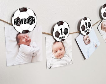 May include: A baby milestone photo banner with black and white soccer ball designs. The banner includes photos of a baby at different ages, with the text "NEWBORN", "1 MONTH", "2 MONTHS", and "3 MONTHS".