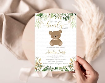 May include: A baby shower invitation with a green and gold floral design. The invitation says "We can't bearly wait!" and features a cartoon brown teddy bear. The invitation includes the name Amelia Jones, the date and time of the shower, and the location.