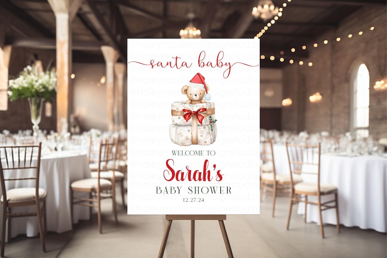 May include: A white rectangular sign featuring the red text santa baby at the top, a watercolor illustration of a teddy bear wearing a red Santa hat sitting on two wrapped gifts, and the text WELCOME TO Sarah's BABY SHOWER 12.27.24 below.