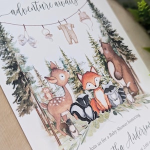 May include: A baby shower invitation with a woodland theme. The invitation features a watercolor illustration of a deer, fox, raccoon, skunk, and bear in a forest setting. The text on the invitation reads "adventure awaits" and "Join us for a Baby Shower honoring Samantha Andersen".