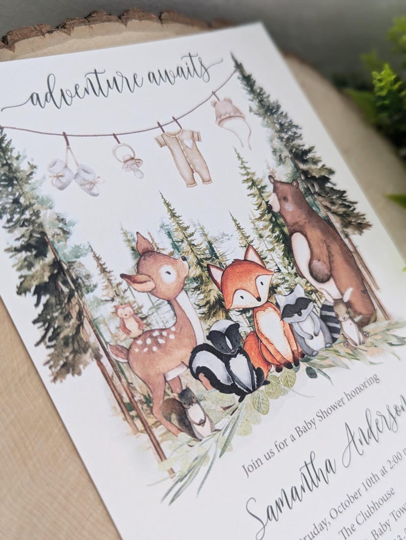May include: A baby shower invitation with a woodland theme. The invitation features a watercolor illustration of a deer, fox, raccoon, skunk, and bear in a forest setting. The text on the invitation reads "adventure awaits" and "Join us for a Baby Shower honoring Samantha Andersen".