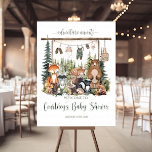 Puede incluir: Un letrero de baby shower con temática de bosque. El letrero presenta una ilustración de acuarela de animales del bosque, incluyendo un zorro, un oso y un mapache. El texto "Adventure Awaits" está en la parte superior, con "Welcome to Courtney's Baby Shower" debajo.