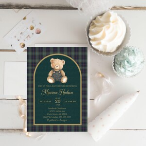 May include: Baby shower invitation featuring a teddy bear illustration on a dark green plaid background. The invitation includes the text "Join us for a baby shower honoring Maureen Hudson" and event details.