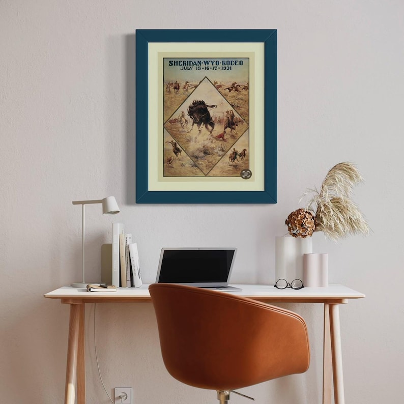 May include: A vintage poster advertising the Sheridan, Wyoming Rodeo, held July 15-16-17, 1931. The poster features a colorful illustration of a cowboy riding a bucking bronco.