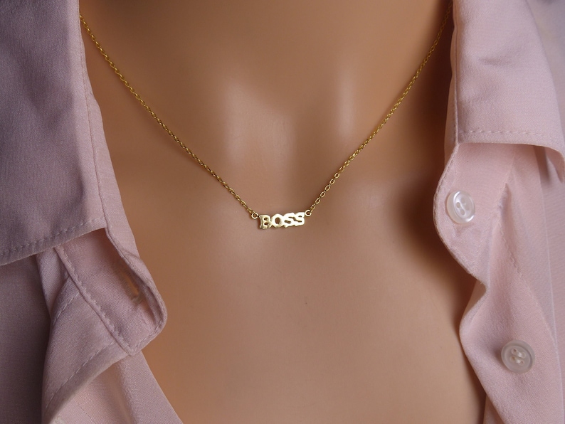 May include: A gold chain necklace with a small pendant that says "BOSS" in block letters.