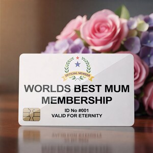 May include: A white membership card with the text "WORLD'S BEST MUM MEMBERSHIP" and "VALID FOR ETERNITY". The card has a gold chip and is set against a backdrop of pink roses and purple hydrangeas.