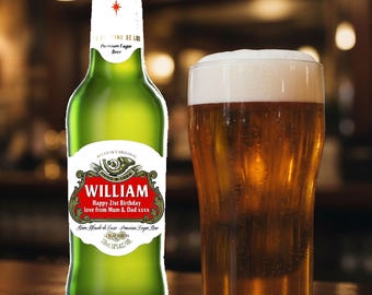 May include: A green beer bottle with a white label and a glass of beer. The label reads "WILLIAM Happy 21st Birthday love from Mum & Dad xxxx". The beer glass is filled with a golden liquid and topped with white foam.