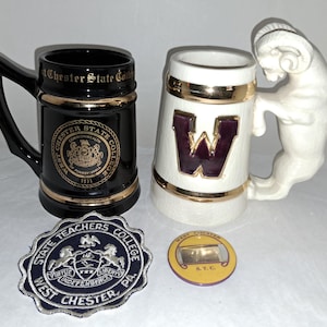 May include: Two ceramic beer steins, one black with gold trim and the text "West Chester State College", the other white with a purple "W" and a ram handle. Also, a patch and a pin with "West Chester" text.