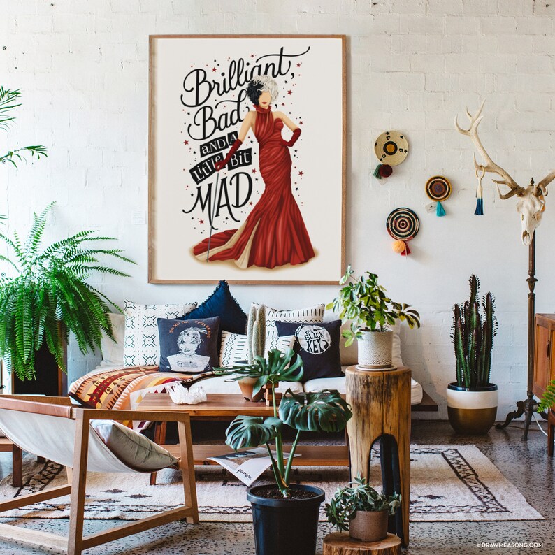 May include: A framed print with a white background and a black and white illustration of a woman in a red dress. The text "Brilliant, Bad and a little bit MAD" is written in black cursive lettering.