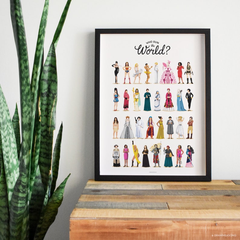 May include: A framed print with the text "Who run the World?" in black cursive lettering. The print features a colorful illustration of 30 women in various outfits and poses.