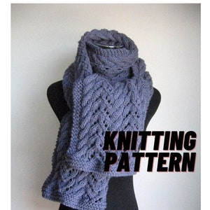 May include: A blue knitted scarf with a cable knit pattern. The scarf is draped over a black mannequin. The text "KNITTING PATTERN" is visible in the image.