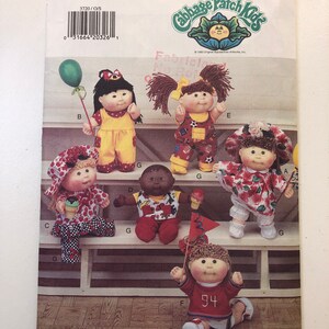 May include: A vintage Butterick sewing pattern for Cabbage Patch Kids dolls. The pattern displays several dolls in diverse outfits, including one with a balloon and another with a flag. The pattern number is 3720.