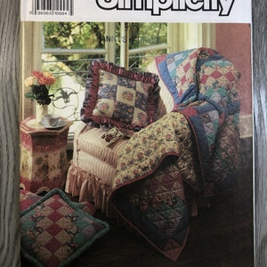 May include: A Simplicity sewing pattern for a quilt with a floral design. The pattern is titled "Shirley Botsford" and includes instructions for making a quilt, pillows, and a throw. The pattern number is 7139.