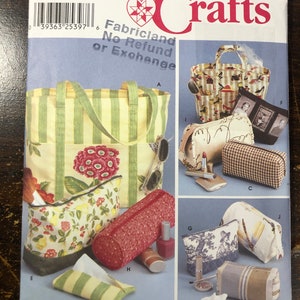 May include: A Simplicity Crafts sewing pattern for making various bags and pouches. The pattern includes instructions for a large tote bag, a smaller zippered pouch, a rectangular makeup bag, a cylindrical makeup bag, and a tissue holder. The pattern is for one size and is available in English, Spanish, and French.