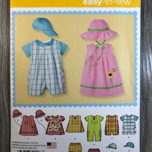 May include: Simplicity sewing pattern number 1447 for easy-to-sew baby clothes. The pattern includes a variety of styles, including dresses, rompers, and shorts. The pattern is designed for sizes XXS-L.