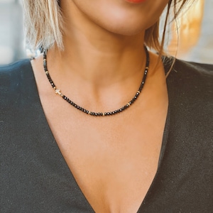Black spinel beaded necklace with cross charm, gold plated silver