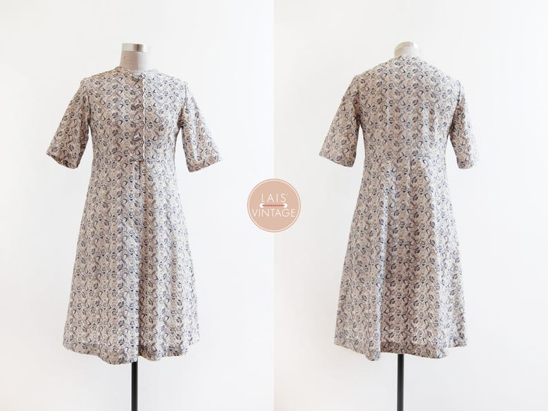 May include: A white dress with a floral pattern and short sleeves. The dress has a button-up front and a slightly flared skirt.