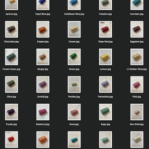May include: A collection of spools of thread in various colors, including apricot, Capri blue, Caribbean blue, celadon, cerulean, chocolate, copper, cream, deep red, eggplant, forest green, ginger, green, lemon, light golden glow, olive, orchid, peridot, periwinkle, pink, purple, rasberry, rose, sage, sea shell, siam, tangerine, teal, turquoise, and white.