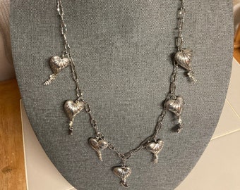 Single stranded necklace of silver hearts on chain