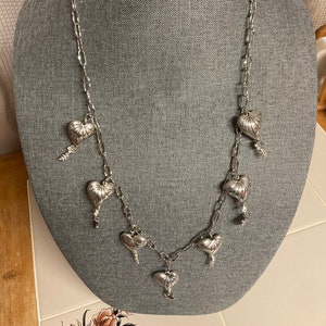 Single stranded necklace of silver hearts on chain