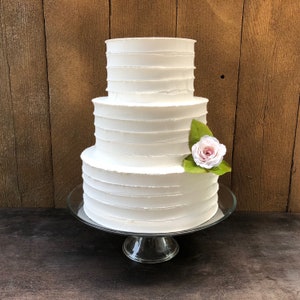 Fake swirl cake. This cake is 10" 8" 6" The tiers are 4" high.  Perfect for a wedding or photo shoot.