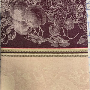 May include: A burgundy fabric with a white floral pattern. The fabric has a striped border with shades of burgundy, green, and white.