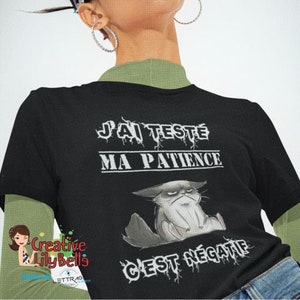 May include: Black t-shirt with white text that reads "J'ai testé ma patience c'est négatif" and a cartoon image of a grumpy cat.