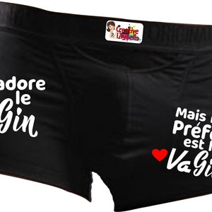 May include: Black boxer shorts with white text that reads "J'adore le Gin Mais mon Préféré est le Va Gin" with two red hearts.