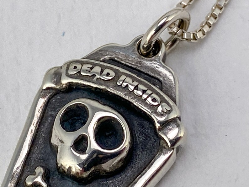 Dead Inside skull + crossbones necklace detail