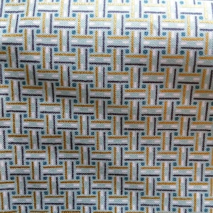 May include: Close-up of a fabric with a repeating geometric pattern. The design features a grid of intersecting lines in teal, navy, and gold against a white background. The fabric has a woven texture.