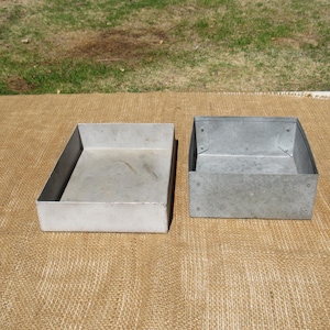 May include: A set of three ceramic mugs with a speckled, cream-colored glaze. Each mug features a different hand-painted design: a blue and green leaf, a yellow flower, and a red berry. The mugs have a simple, modern design.