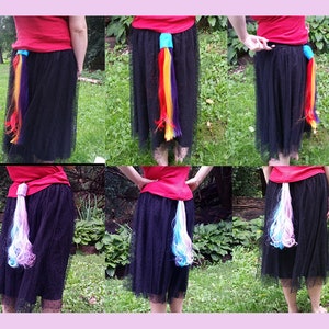 May include: A person wearing a black skirt with a colorful, rainbow-colored ponytail attached to the back. The ponytail is made of yarn and is about 18 inches long.