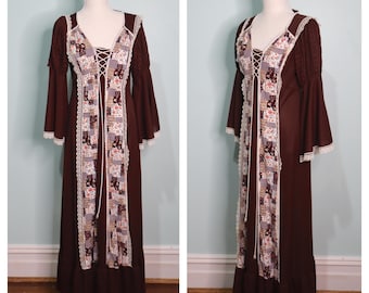 May include: A long brown maxi dress with a lace trim and a patchwork floral design. The dress has a V-neckline and long bell sleeves.