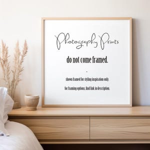 May include: A square light wood frame containing a white sign with black text that reads: Photography Prints do not come framed. - shown framed for styling inspiration only. for framing options, find link in description.