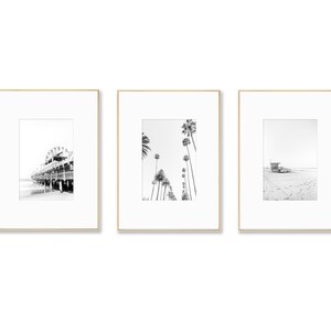 Set of 3 Santa Monica black and white photography prints showing the ferris wheel, palm trees and a lifeguard stand on the beach.