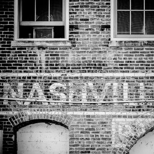 Nashville Photo Print shown in black and white. Features the city's name on an old brick building.