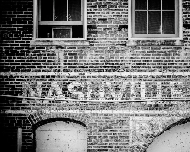 Nashville Photo Print shown in black and white. Features the city's name on an old brick building.