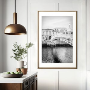Photography print of Ha'penny Bridge in Dublin Ireland.  Shows water underneath with Merchant's bar in background.  Black and white version.