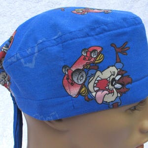 Comic character scrub hat, chemo cap, cancer hat, chef&#39;s hat, chemotherapy cap with a cotton terry cloth sweat band.   Handmade in the USA.