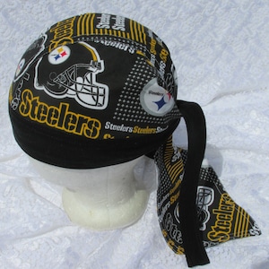 May include: Black and yellow bandana with a Pittsburgh Steelers logo and the word "Steelers" repeated throughout. The bandana is tied around a white mannequin head.