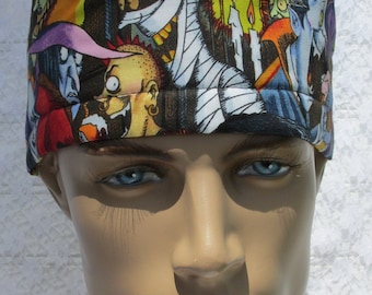 May include: A black and white patterned surgical scrub hat with a variety of spooky characters, including a mummy, a vampire, and a witch. The hat is worn by a mannequin with a neutral expression.