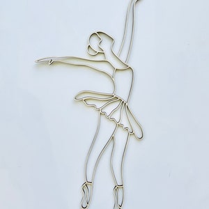May include: A line drawing of a ballerina in a simple pose with her arms raised above her head. The ballerina is wearing a tutu and pointe shoes.
