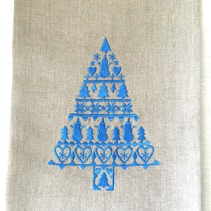 May include: A blue embroidered Christmas tree design on a linen kitchen towel. The tree is decorated with snowflakes, hearts, and snowmen.