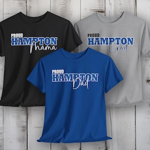May include: Three t-shirts with the text "Proud Hampton" and a different word below it. The first shirt is black with the word "Mama", the second shirt is gray with the word "Grad", and the third shirt is blue with the word "Dad".