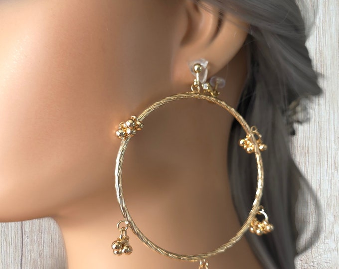 1 pair of gold tone CLIP ON hoop drop earrings - 4" long gold tone twisted hoop with ball charm details - Clip on or pierced options