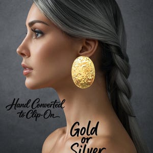 May include: Gold oval clip-on earrings with a textured surface. The earrings are worn by a person with gray hair. The image also includes the text "Hand Converted to Clip-On" and "Gold or Silver".