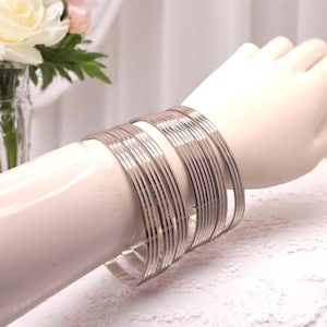 Set of 7  stainless steel round patterned stacking bangles,  inner diameter 68mm - large bangles fitting larger sized hands