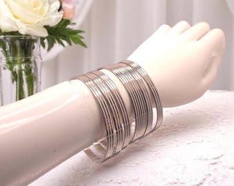 Set of 7  stainless steel round patterned stacking bangles,  inner diameter 68mm - large bangles fitting larger sized hands